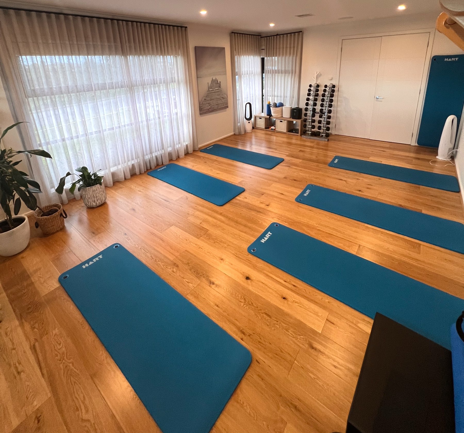 Tru'tone Pilates studio with the wall sign and mats set up for class